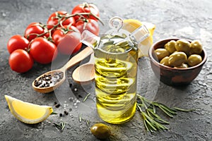 Composition with fresh olive oil on table