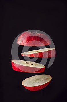 Composition of fresh organic apple , village style. wooden table and black background. fresh organic cut  apple on air, slices on