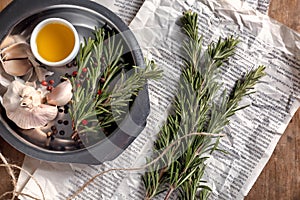 Composition with fresh rosemary on wooden table