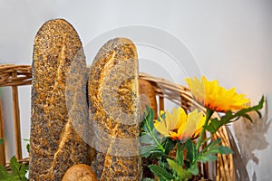Composition with freshly baked bread and yellow flowers closeup