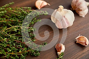 Composition of garlic and tyme. Fresh green thyme and garlic cloves.