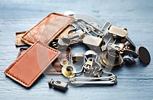 Composition with garment accessories for jeans on blue wooden background