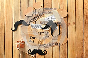 Composition with gift box and papers with text HAPPY FATHER\'S DAY on wooden background