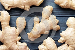 Composition of ginger root on a blue wooden