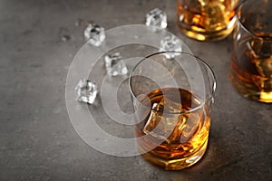 Composition with glass of whiskey on table