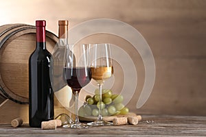 Composition with glasses and bottles of different wine on wooden table
