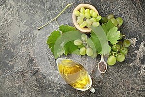 Composition with grape seed oil on grey textured background