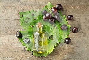 Composition with grape seed oil on wooden background