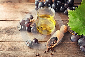 Composition with grape seed oil on wooden background