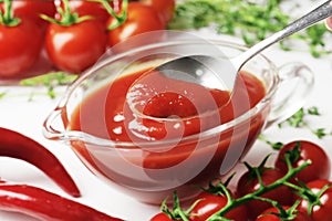 Composition of a gravy boat filled with delicious tomato sauce,