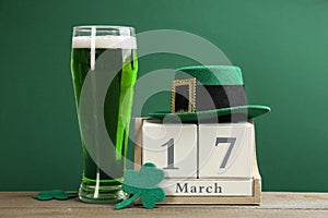 Composition with green beer and clover leaves on table. St. Patrick`s Day celebration