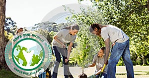 Composition of green globe logo and earth day text over volunteers planting tree in countryside