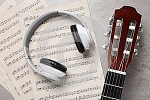 Composition with guitar and music notations on table, flat lay