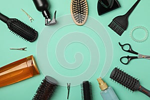 Composition hairdresser accessories on mint background, top view