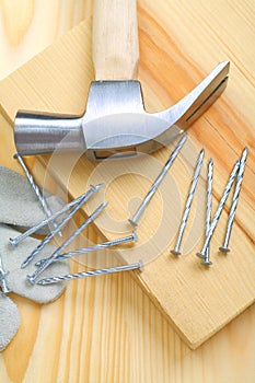 Composition of hammer and nails with glove closeup