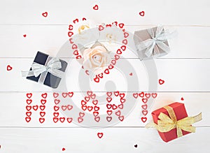 Composition of handmade paper roses in heart, gift boxes. Lettering HEART of sequins hearts on wooden table. Content for Birthday