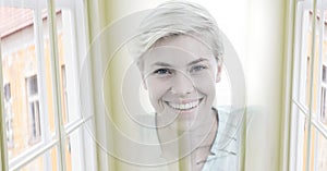 Composition of happy caucasian busineswoman looking at camera and smiling with double exposure