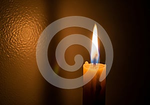 The composition highlights simplicity and focus on the flame's gentle