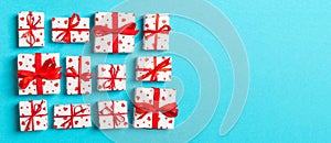 Composition of holiday white gift boxes with red hearts on colorful background. Valentine\'s day concept