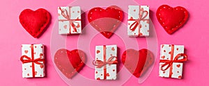 Composition of holiday white gift boxes and red textile hearts on colorful background. Valentine\'s day concept