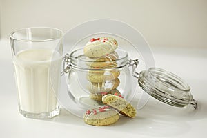 Composition with homemade mint gingerbread cookies with matcha and sublimated strawberries in plate, glass of milk, jug