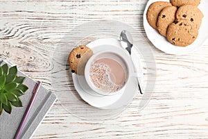 Composition with hot cocoa drink and cookies on wooden background, top view