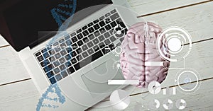 Composition of human brain and medical data processing over desk with laptop computer