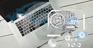 Composition of human brain and medical data processing over desk with laptop computer