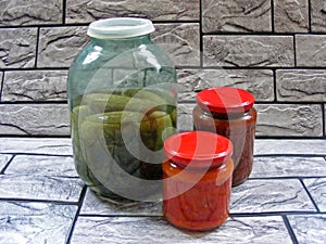 Composition with jars of pickled vegetables. Marinated food