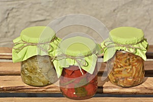 Composition with jars of pickled vegetables. Marinated food