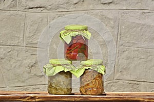 Composition with jars of pickled vegetables. Marinated food