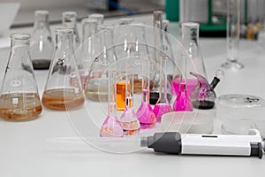 Composition of laboratory material with colored liquids in realistic glass pots