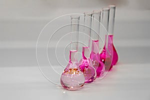 Composition of laboratory material with colored liquids in realistic glass pots