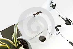 Composition with laptop, desklamp and glasses