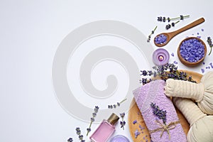 Composition with lavender flowers and natural cosmetic products on background, top view