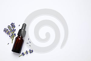 Composition with lavender flowers and natural essential oil on white background