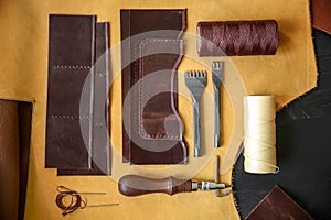 Composition with leather and craft tools on table