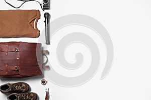 Composition with leather tourist backpack and camping equipment on white background, flat lay. Space for text