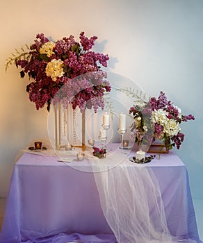 Composition of lilac flowers on the table