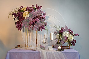Composition of lilac flowers on the table