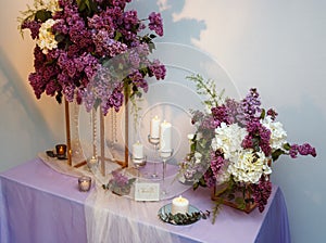 Composition of lilac flowers on the table