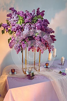 Composition of lilac flowers on the table
