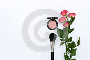 Composition with makeup cosmetics, brushes, shadoes and flowers on white background