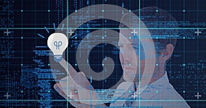 Composition of man touching virtual screen with light bulb icon and data processing