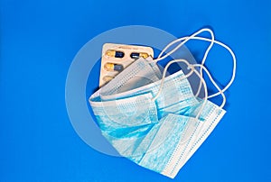 Composition of medical protective equipment isolated on blue background. Flu disease virus spreading in Europe, virus protection