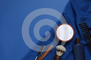 Composition with men`s shaving accessories on blue background, flat lay. Space for text