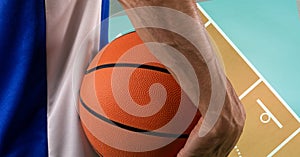 Composition of midsection of male basketball player with ball over basketball court