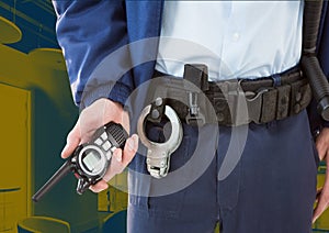 Composition of midsection of male security guard holding walkie talkie over office background