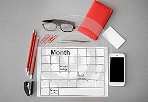 Composition with mobile phone, appointment calendar and stationery on light background