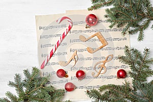 Composition with music notes and decorations on wooden background